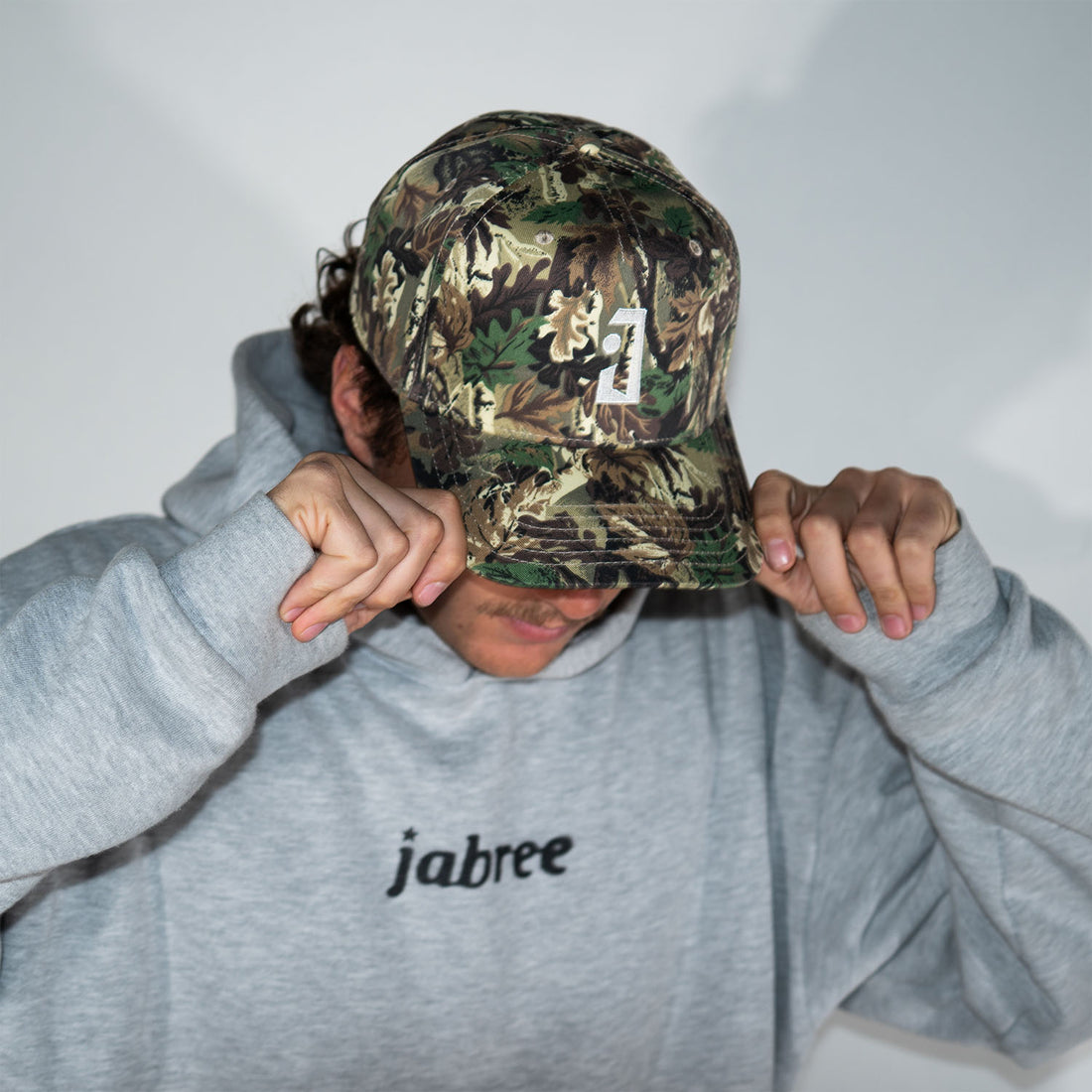 Camo Jab Logo Trucker with white embroidery, front view